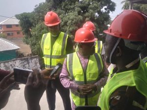 LRRRC Executive Director Rev. Festus Logan along with the Ministers of State and Internal Affairs, including the Country Representative of the United Nation High Commissioner For Refugee (UNHCR) for an inspection tour at its Headquarters construction site in Oldest Congo Town.